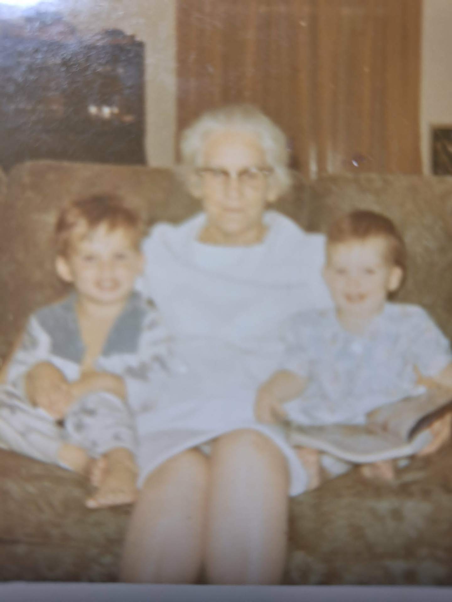 Original photo before FixPix restoration — Grandma with the grandkids — sharp again.